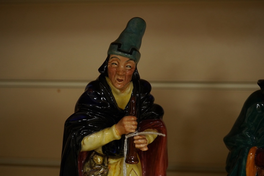 Two Royal Doulton figures comprising; The Mask Seller and Pied Piper together with three other figures and a pair of alabaster bookends, largest 24cm high. Condition - mostly fair/good